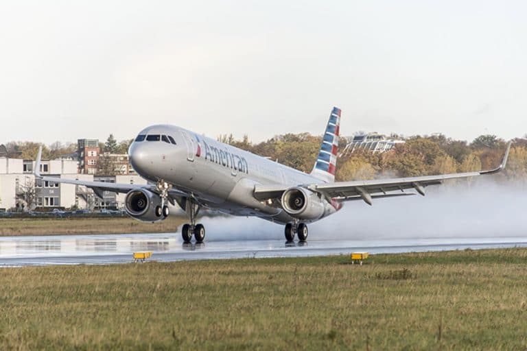 American Airlines tops 1Q profit views; unveils pay boost