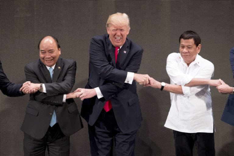 You’ve heard of ‘grip and grin’? Trump goes for grip and grimace