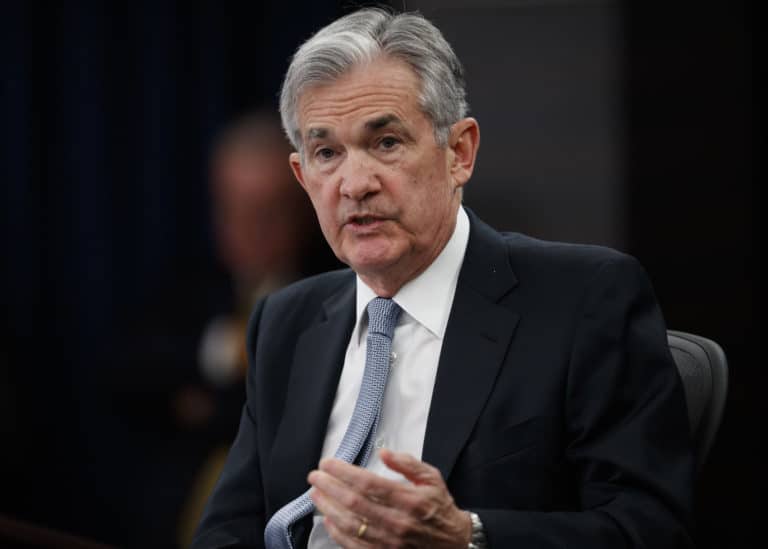 Fed raises rates for 4th time this year but sees fewer hikes