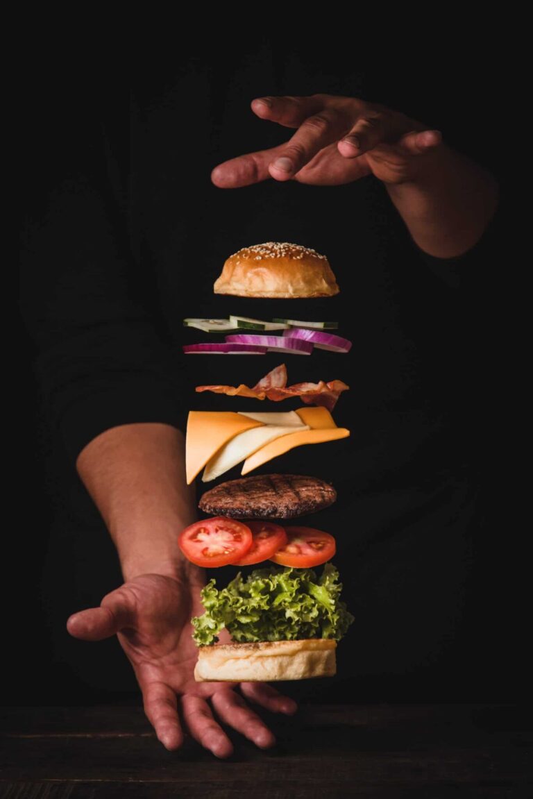 timelapse photo of man holding burger