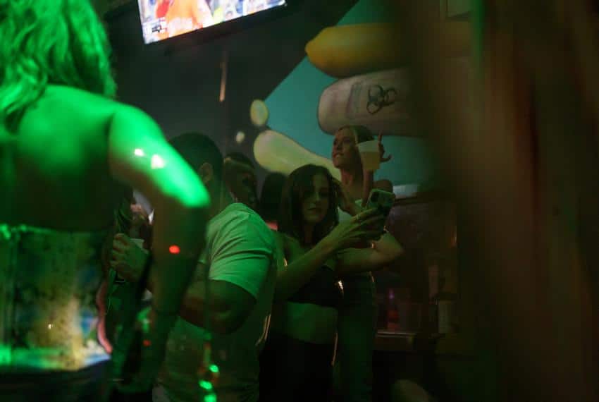 As the night wore on, more and more people gathered inside The Vault in downtown San Marcos for drinks and dancing. Gov. Gre…