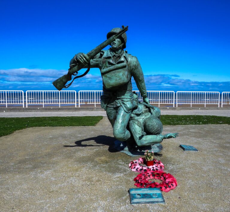 statue of man holding red bouquet